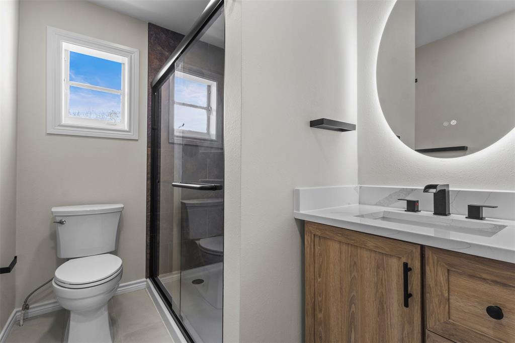4941 North Hall Street Dallas, TX 75235 - Photo 10 of 18 Bathroom featuring vanity and a stall shower