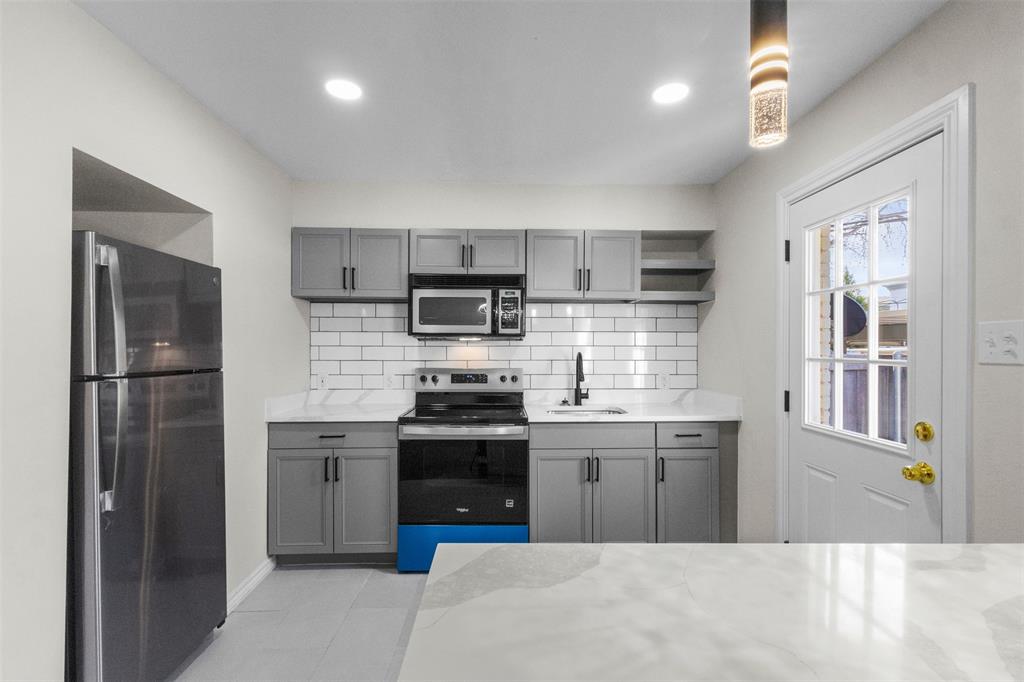 4941 North Hall Street Dallas, TX 75235 - Photo 3 of 18 Kitchen featuring open shelves, gray cabinetry, stainless steel appliances, decorative backsplash, and recessed lighting