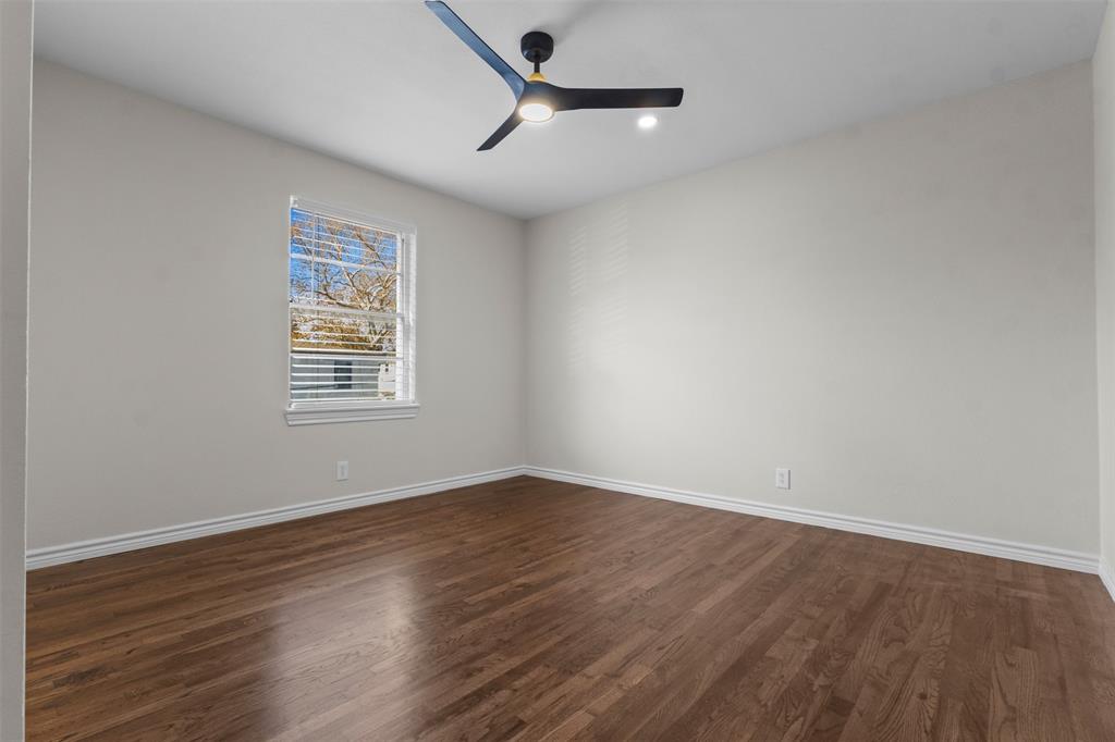 4941 North Hall Street Dallas, TX 75235 - Photo 8 of 18 Unfurnished room featuring dark wood-style flooring and ceiling fan