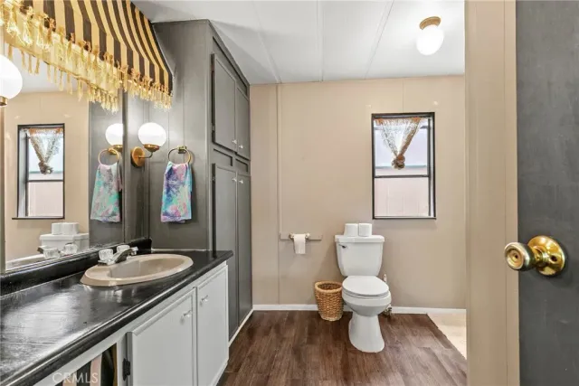 a kitchen with stainless steel appliances granite countertop a refrigerator a sink dishwasher a stove with white cabinets and countertops