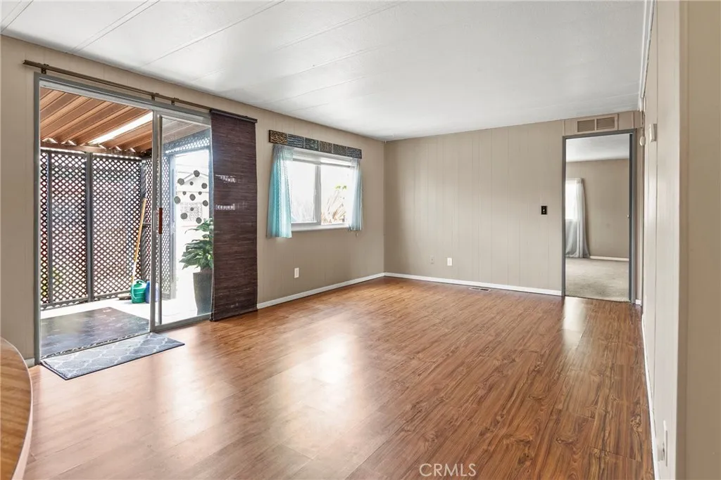 519 West Taylor Street, Unit 252 Santa Maria, CA 93458 - Photo 17 of 52 a view of an empty room with glass door and wooden floor