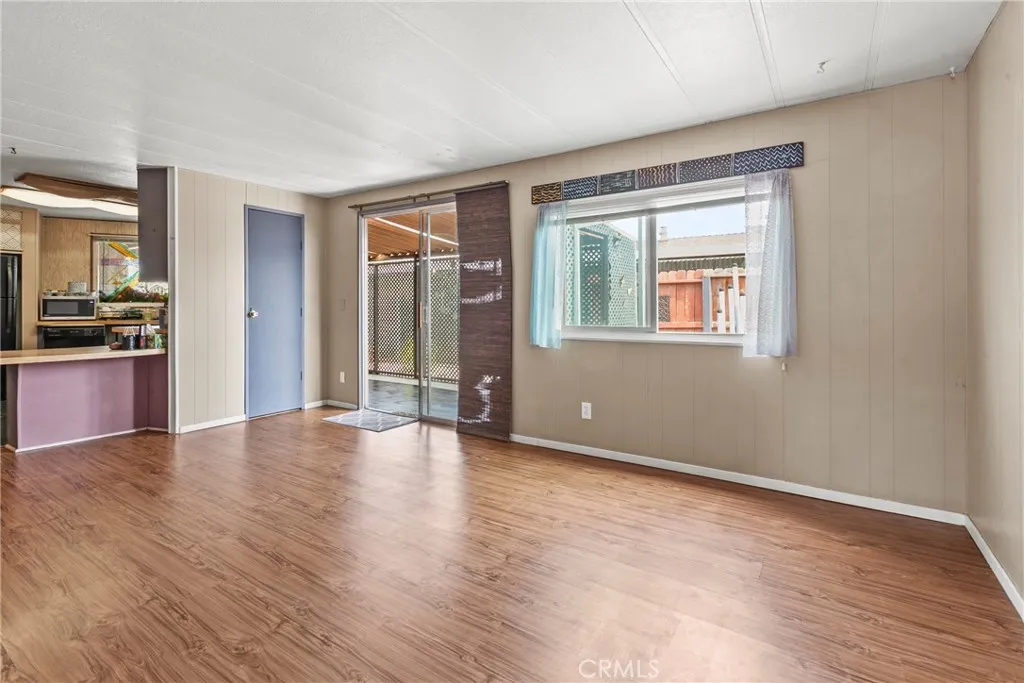 519 West Taylor Street, Unit 252 Santa Maria, CA 93458 - Photo 22 of 52 a view of an empty room with wooden floor and a window