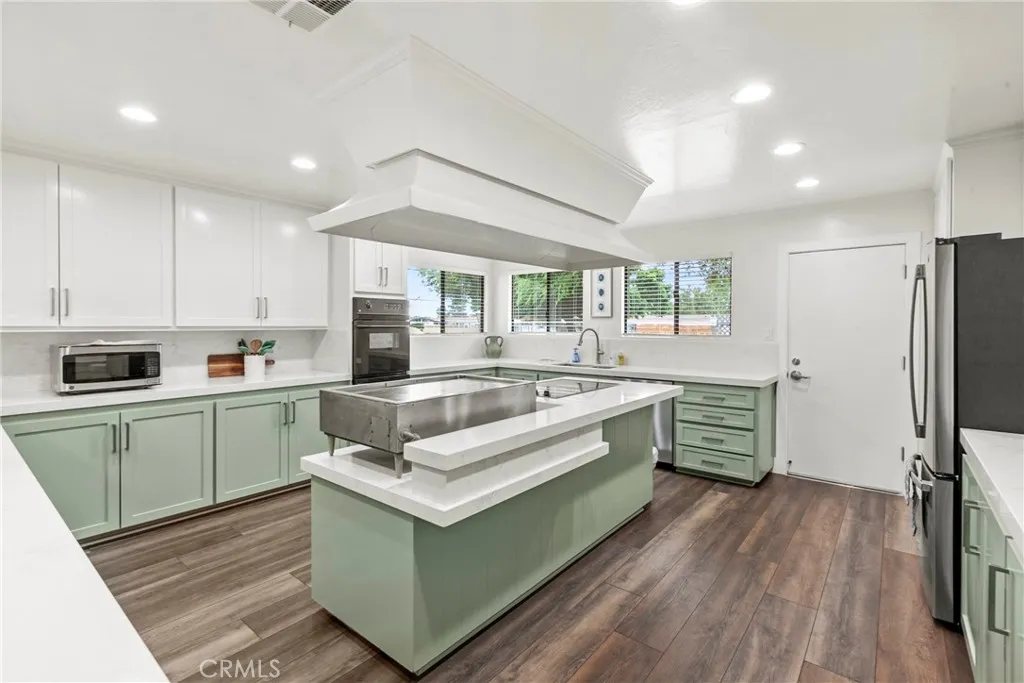 519 West Taylor Street, Unit 252 Santa Maria, CA 93458 - Photo 31 of 52 a kitchen with stainless steel appliances white cabinets a sink a stove a refrigerator and island