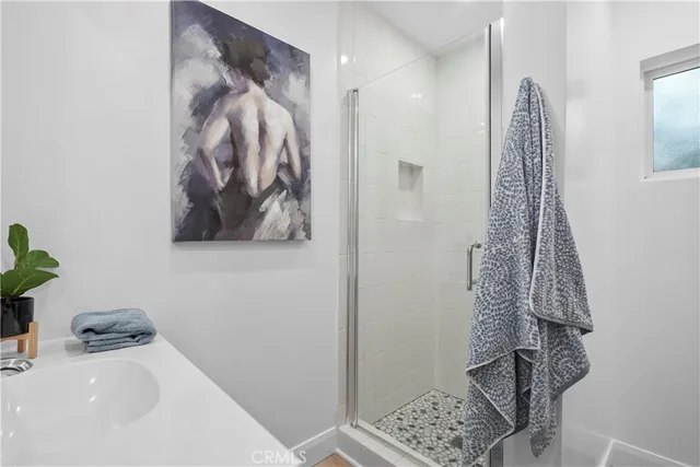 a bathroom with a shower and a sink