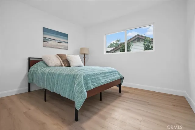 a bedroom with a bed and a painting on the wall