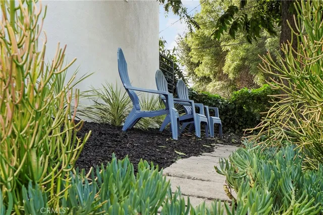 a view of a house with a yard and sitting area