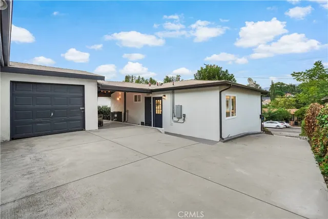 a view of a house with a backyard and garage