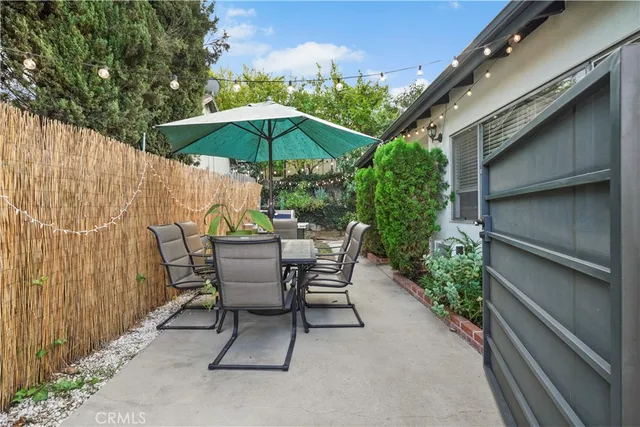 a patio with a patio table and chairs