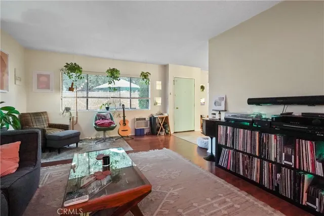 a living room with furniture a rug and a large window