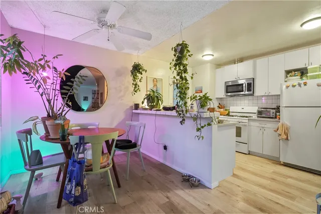 a kitchen with cabinets and wooden floor