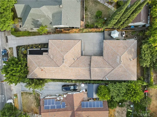 a view of a house with a yard and potted plants