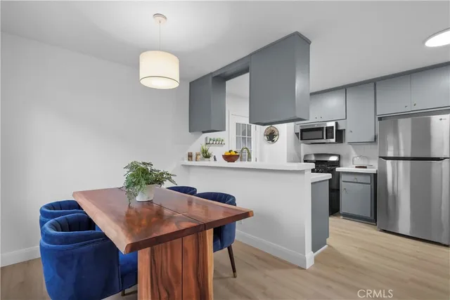 a kitchen with refrigerator cabinets and wooden floor
