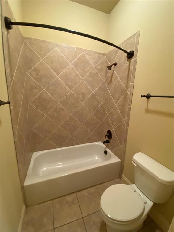 2222 Kirby Street Dallas, TX 75204 - Photo 6 of 25 Full bathroom featuring a white bathtub, diamond-patterned tiled shower surround, oil-rubbed bronze fixtures, and a tile floor
