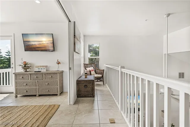 a view of a hallway to bedroom with wooden floor