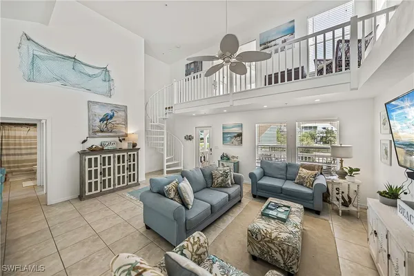 a kitchen with stainless steel appliances granite countertop a sink a stove a refrigerator cabinets and a window