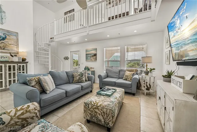 a living room with furniture a large window and a flat screen tv