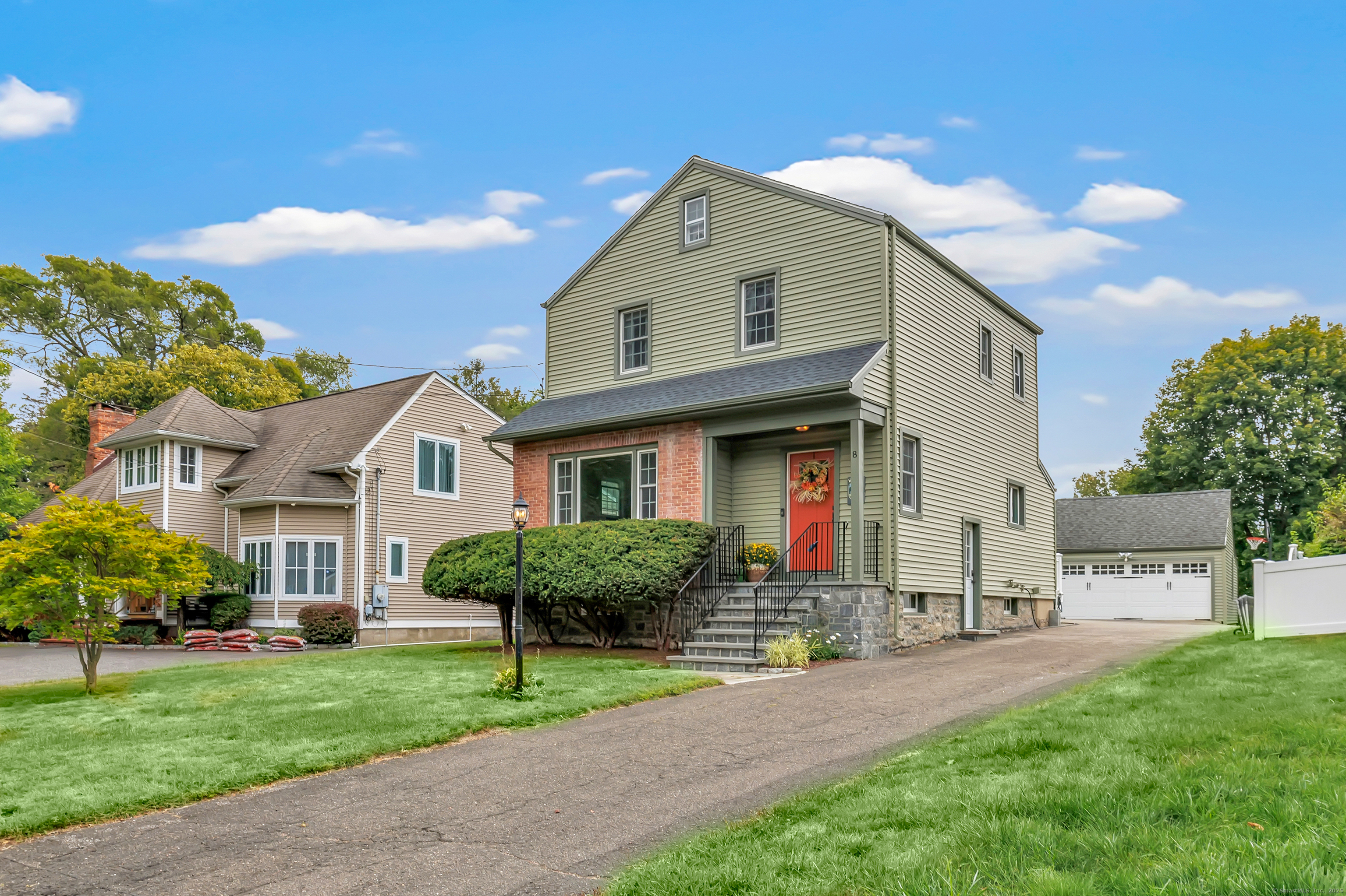8 Thomas Street Trumbull, CT 06611 - Photo 1 of 1 a front view of a house with a yard and garage