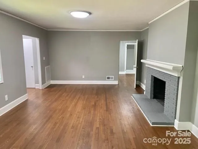 wooden floor in an empty room with a fireplace