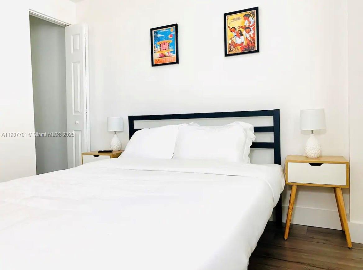 821 Southwest 2nd Street, Unit 6 Miami, FL 33130 - Photo 13 of 15 a bedroom with a bed and a wall painting