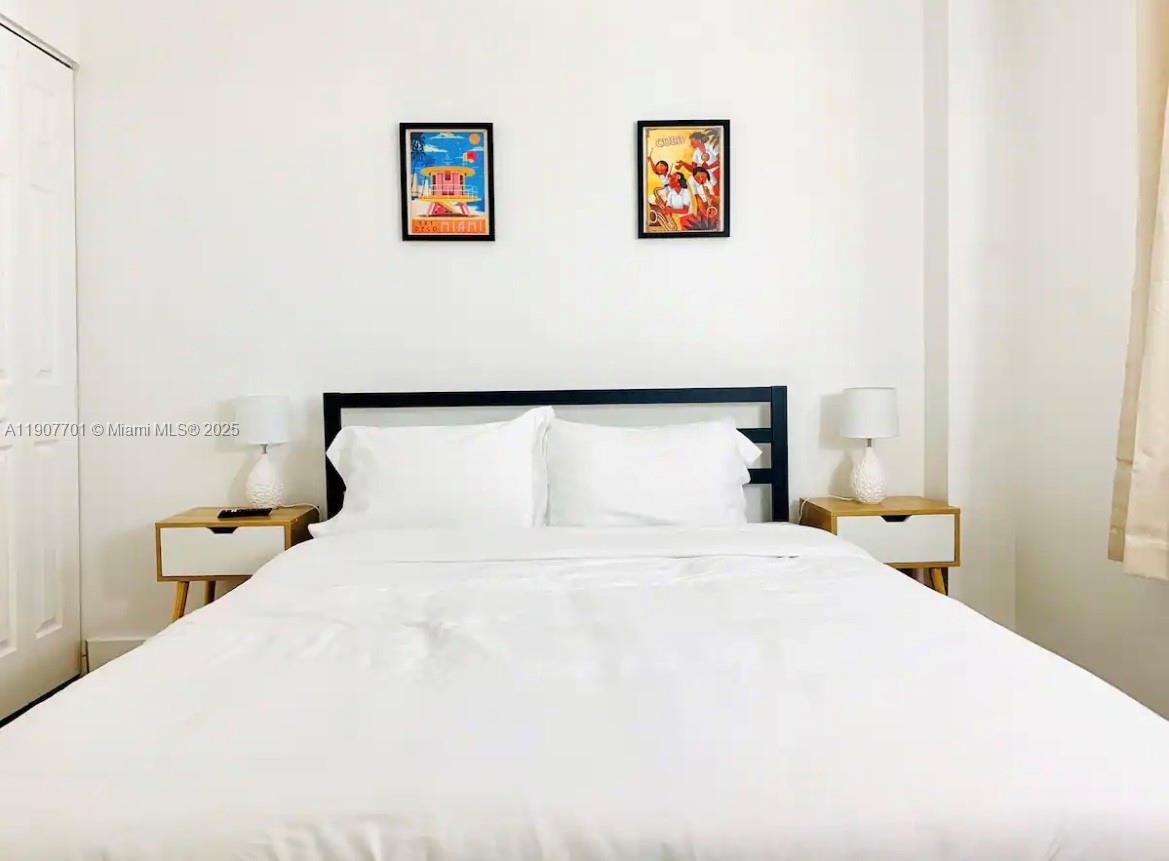 821 Southwest 2nd Street, Unit 6 Miami, FL 33130 - Photo 14 of 15 a bedroom with a bed and painting on the wall