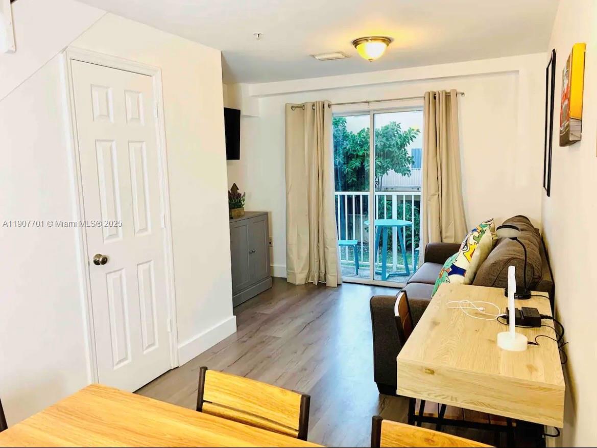 821 Southwest 2nd Street, Unit 6 Miami, FL 33130 - Photo 2 of 15 a bedroom with a bed and wooden floor