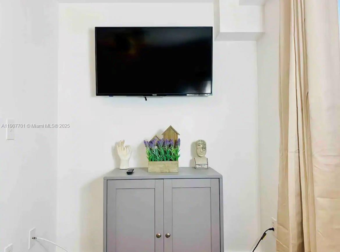821 Southwest 2nd Street, Unit 6 Miami, FL 33130 - Photo 5 of 15 a living room with a flat screen tv and a wall painting