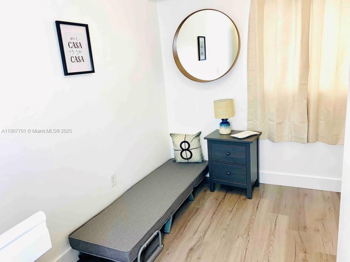 821 Southwest 2nd Street, Unit 6 Miami, FL 33130 - Photo 6 of 15 a view of a room with wooden floor and furniture