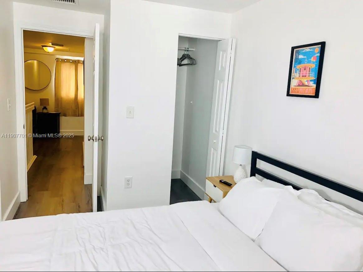 821 Southwest 2nd Street, Unit 6 Miami, FL 33130 - Photo 8 of 15 a bedroom with a bed and painting on the wall