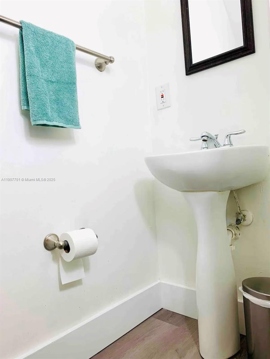 821 Southwest 2nd Street, Unit 6 Miami, FL 33130 - Photo 9 of 15 a bathroom with a sink and a mirror