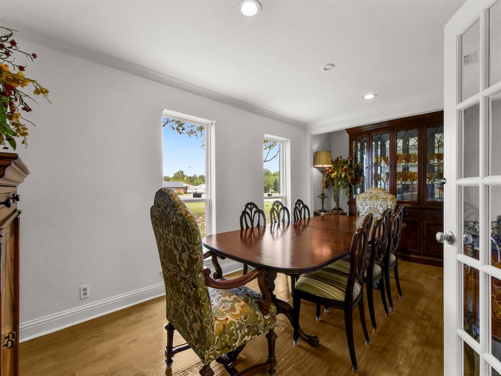 9867 Dripping Spring Road Denison, TX 75021 - Photo 12 of 40 Dining area featuring wood-finish flooring, two large windows, crown molding, and recessed lighting