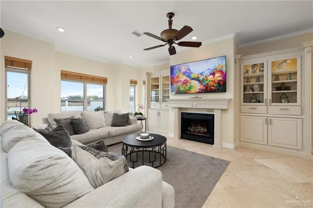a kitchen with kitchen island granite countertop a sink stove cabinets and refrigerator