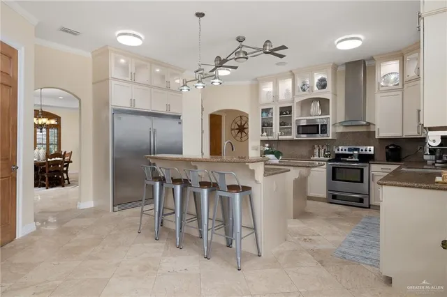 a kitchen with stainless steel appliances granite countertop a sink stove and cabinets