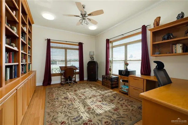 a spacious bedroom with a bed a window and a flat screen television