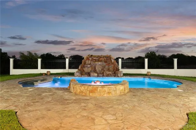 a view of a swimming pool and lounge chair