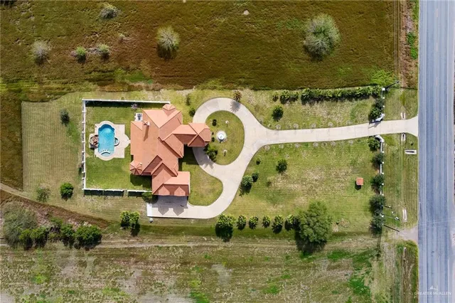 an aerial view of a house with a swimming pool