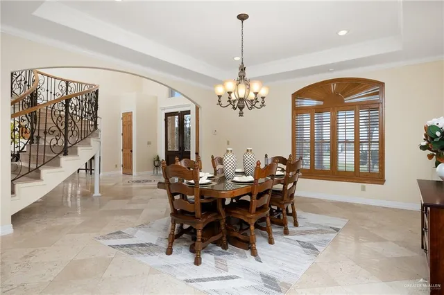 a living room with couch chairs and a large window