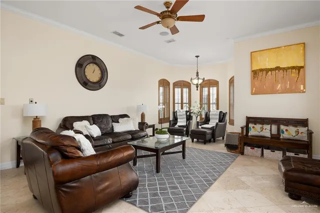 a living room with furniture ceiling fan and a window