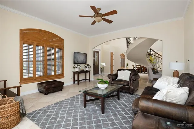 a living room with furniture kitchen view and a chandelier