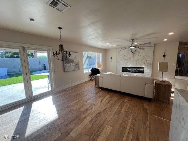2712 Rialto Road Las Vegas, NV 89108 - Photo 9 of 54 Living area featuring wood finished floors, ceiling fan, a chandelier, recessed lighting, and a fireplace