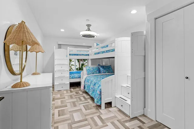 a bed room with a bed and a mirror