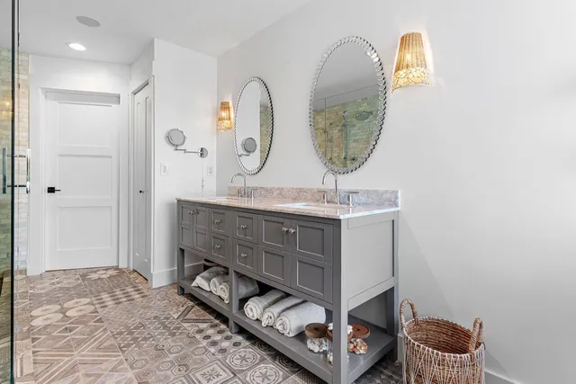 a bathroom with a sink mirror and vanity