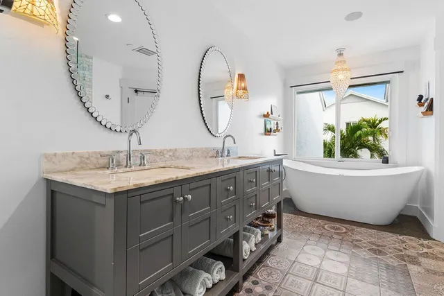 a spacious bathroom with a granite countertop sink and a mirror