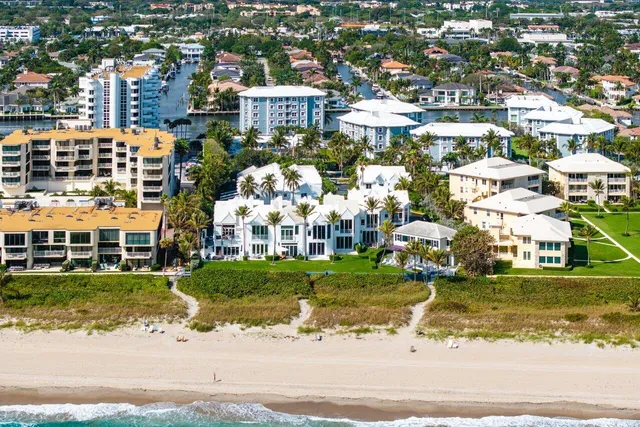 a city view with lawn chairs and ocean view
