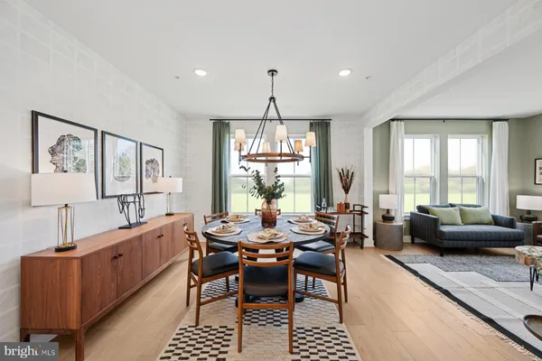 a dining room with furniture a chandelier and window