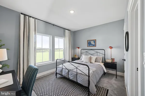 a bedroom with a bed and a large window