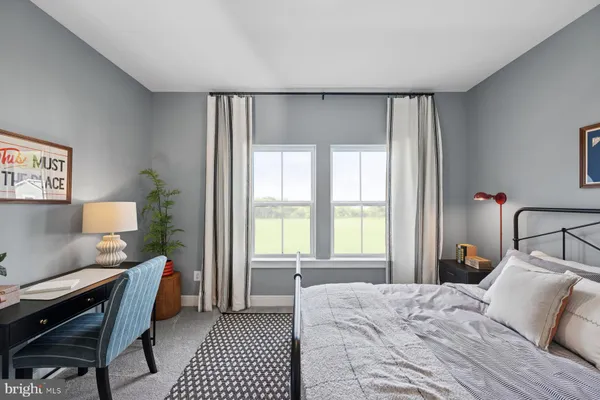 a bedroom with furniture and a window