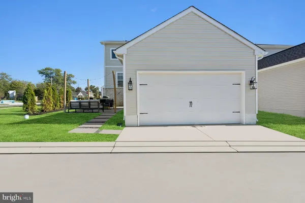 a view of backyard of house and car parked