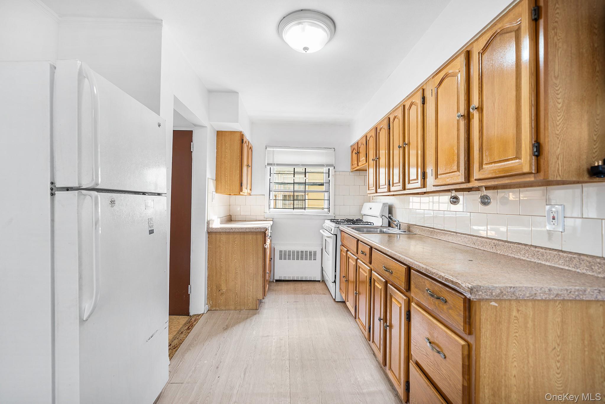 27-11 Deerfield Road Queens, NY 11691 - Photo 12 of 43 a kitchen with refrigerator a sink and dishwasher