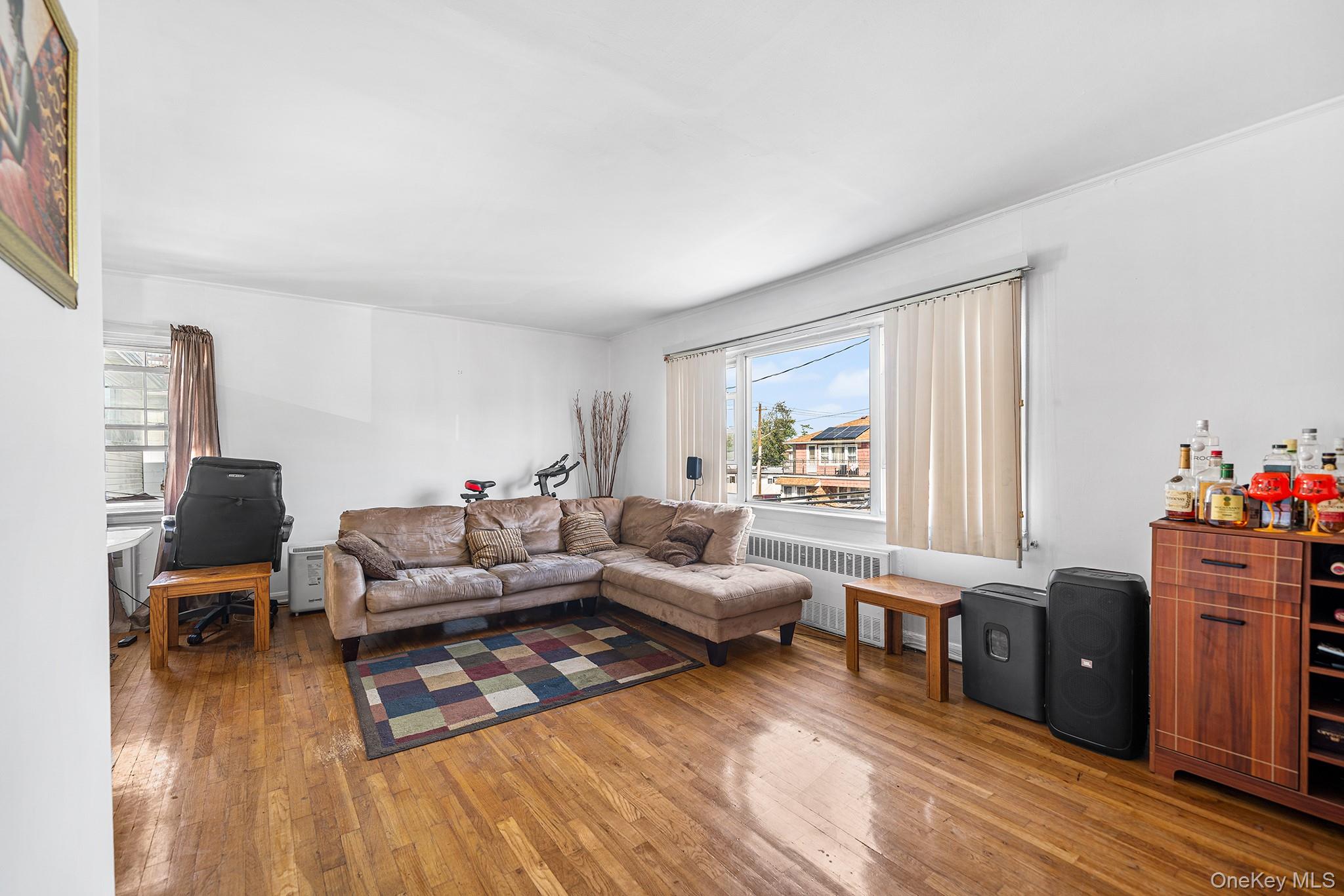 27-11 Deerfield Road Queens, NY 11691 - Photo 25 of 43 a living room with furniture and a wooden floor
