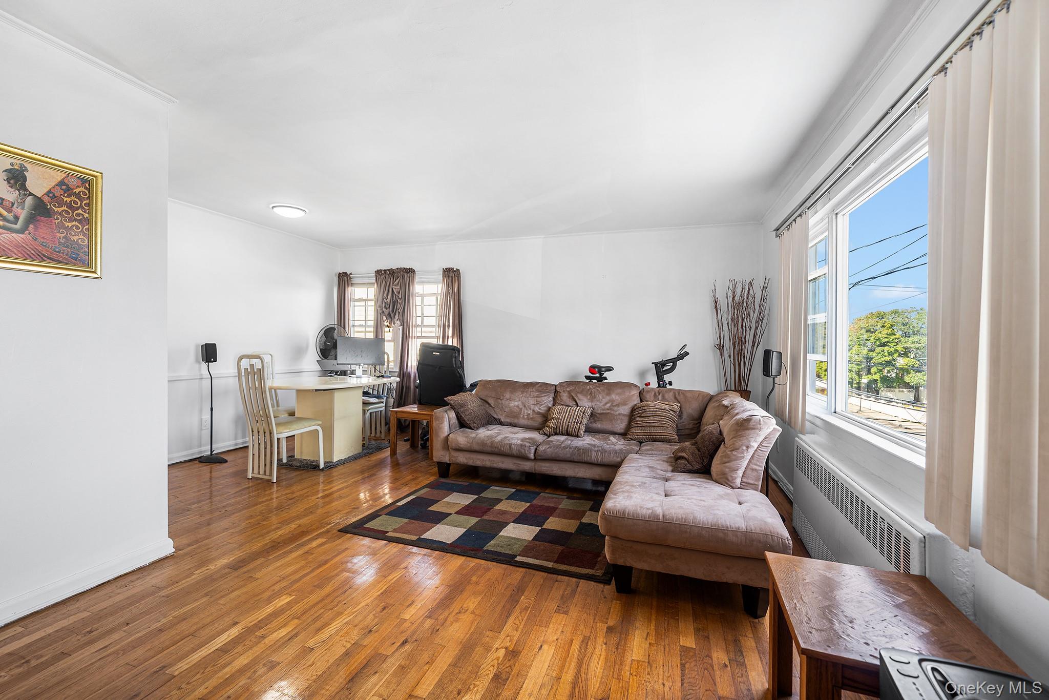 27-11 Deerfield Road Queens, NY 11691 - Photo 26 of 43 a living room with furniture and a wooden floor